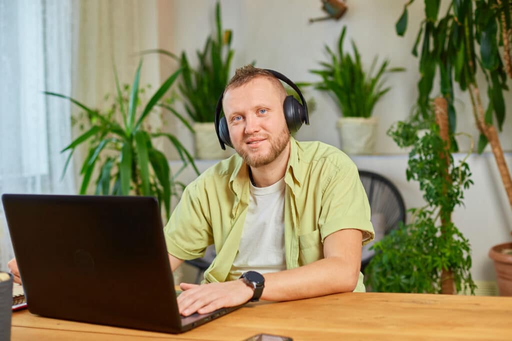 Happy Man wearing wireless headphones watch webinar, trainning, course