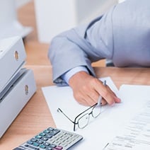 Man Calculating Shareholder Basis at His Desk